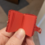 A tiny journal, open, showing pages inside